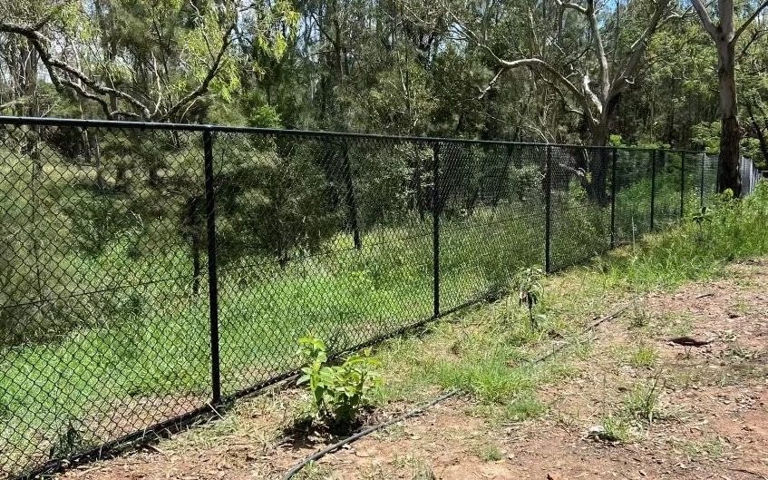 Black PVC chainwire fence installed in park