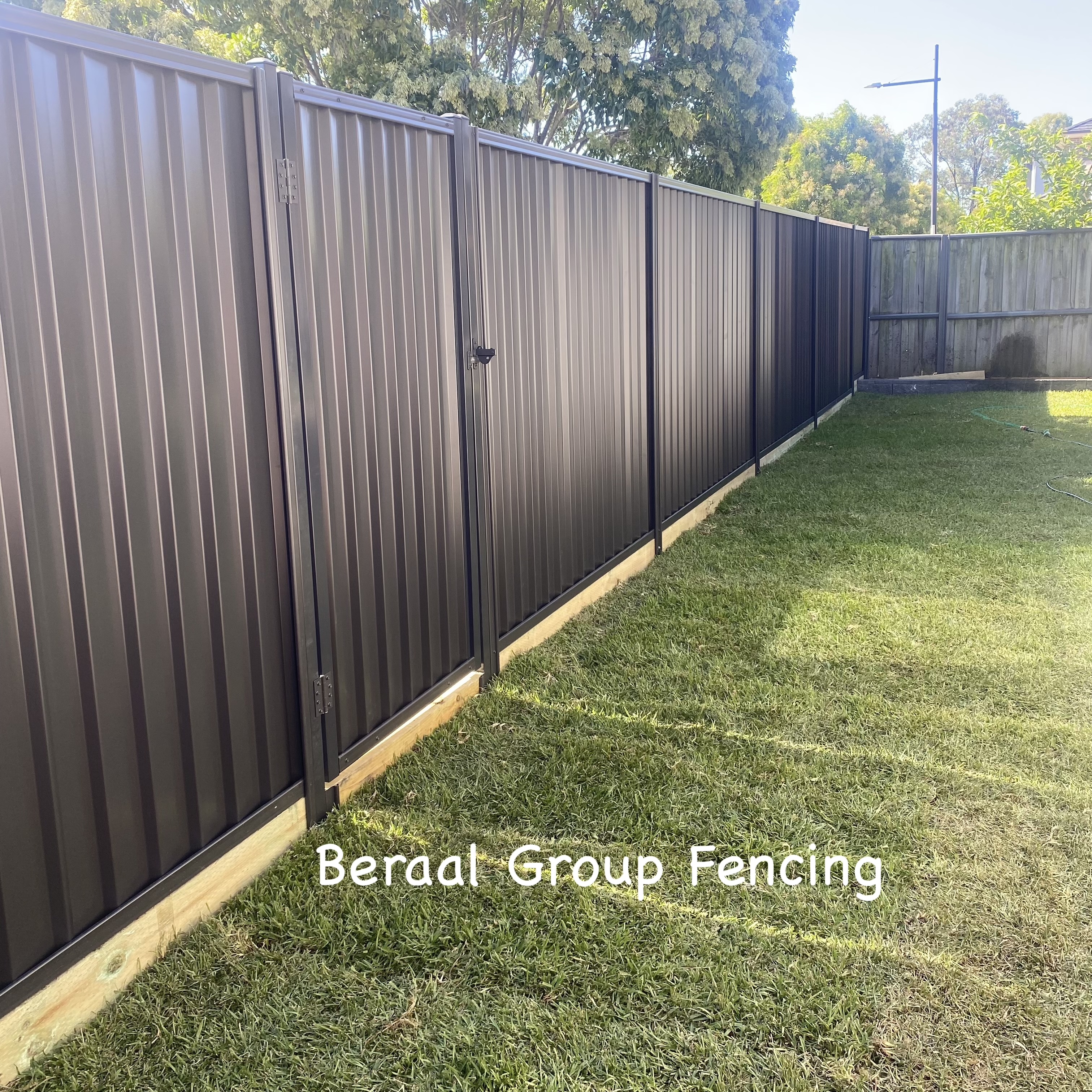 Colorbond fence with timber sleeper
